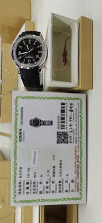 Patek Philippe watch with black rubber strap in box beside certificate card
