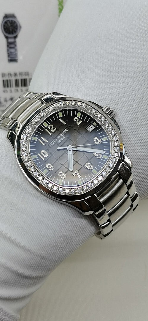 Luxury wristwatch with black dial, silver bezel with diamond accents, and metal bracelet