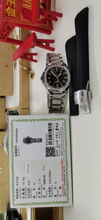 Luxury wristwatch angled view with black dial and diamond-studded silver bezel