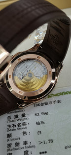 Open-back watch showing mechanical movement with brown leather strap
