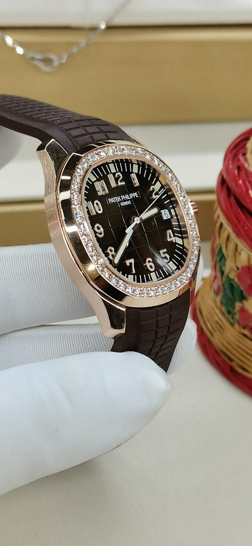 Brown leather strap watch with black dial and diamond bezel, crown on right