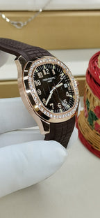 Brown leather strap watch with black dial and diamond bezel, crown on right