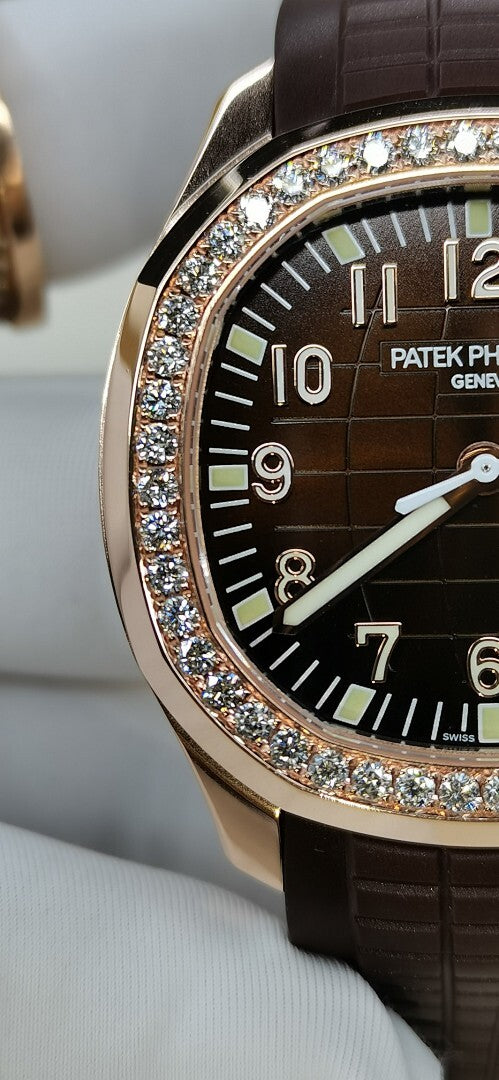 Close-up of black dial wristwatch with diamond bezel and brown leather strap