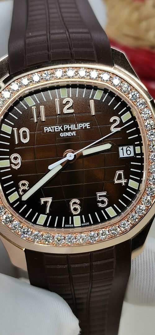 Close-up of black dial wristwatch with diamond bezel and brown leather strap