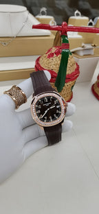 Brown leather strap wristwatch with black dial and diamond-set bezel
