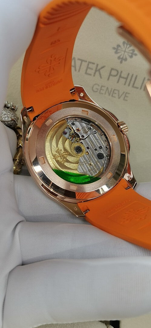 Patek Philippe watch with orange rubber strap, rose-gold caseback view of movement