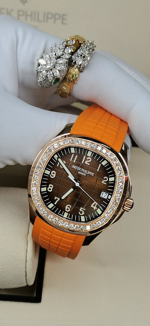 Patek Philippe watch with orange rubber strap, dark dial, diamond bezel, rose-gold case
