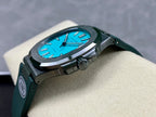 Wristwatch on cushion, blue dial, green strap, round dark case