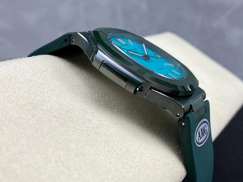 Wristwatch side view with blue dial, green strap, AMG shield on strap