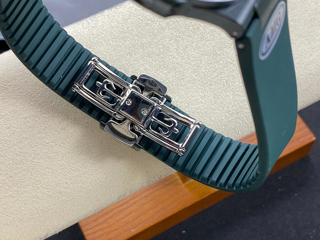 Patek Philippe watch bracelet detail with dark green rubber links and metal clasp