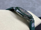 Patek Philippe watch side angle with dark green case, dial window, and AMG tag