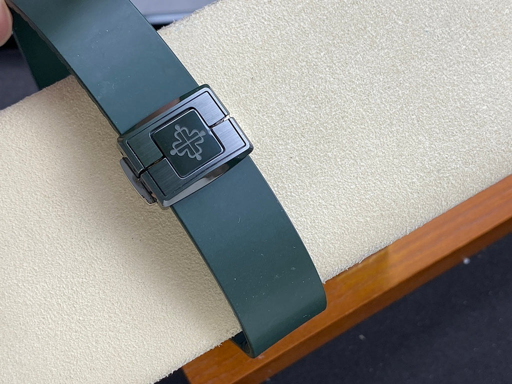 Patek Philippe watch clasp on dark green strap with engraved emblem