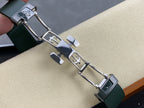 Patek Philippe watch bracelet clasp with green links and silver hardware, engraved markings