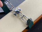 Patek Philippe watch bracelet links with dark teal rubber strap band and metal clasp.
