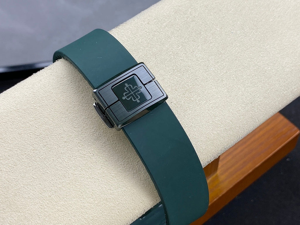 Patek Philippe watch clasp with dark teal strap and square metal buckle detail.