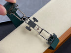 Patek Philippe watch bracelet with silver clasp hardware on green strap