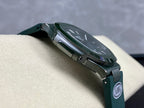 Patek Philippe watch with green strap and silver case, side view with AMG badge