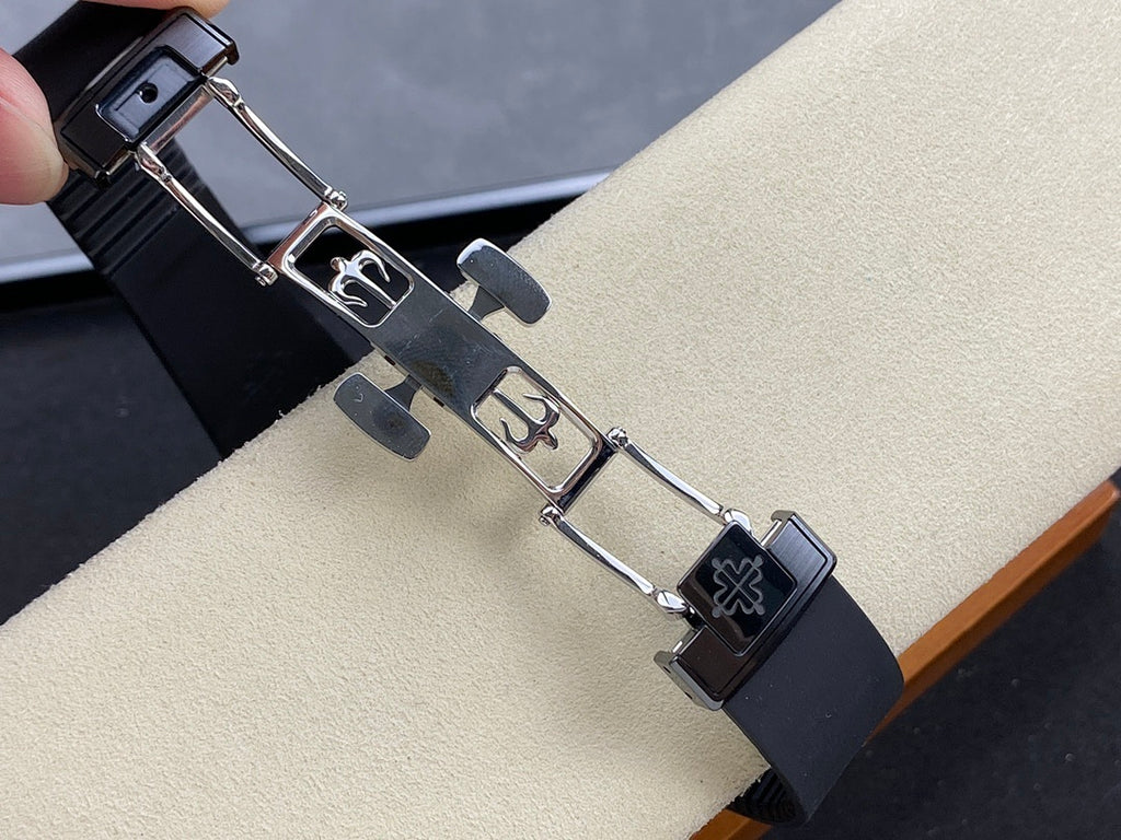 Luxury wristwatch strap with metal clasp and links, dark rubber band with emblem panel