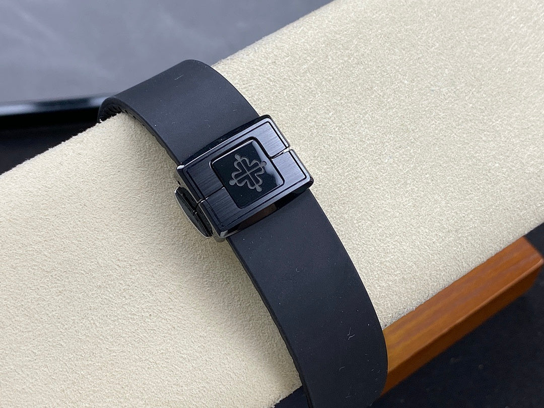 Luxury wristwatch on dark rubber strap with square clasp and engraved logo panel