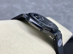 Luxury wristwatch angled view with dark dial and dark rubber strap, AMG logo visible