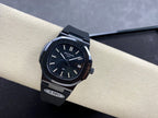 Luxury wristwatch on dark strap with dark dial, silver baton markers, and date window