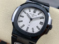 Patek Philippe watch with silver dial, dark bezel, black rubber strap, date window
