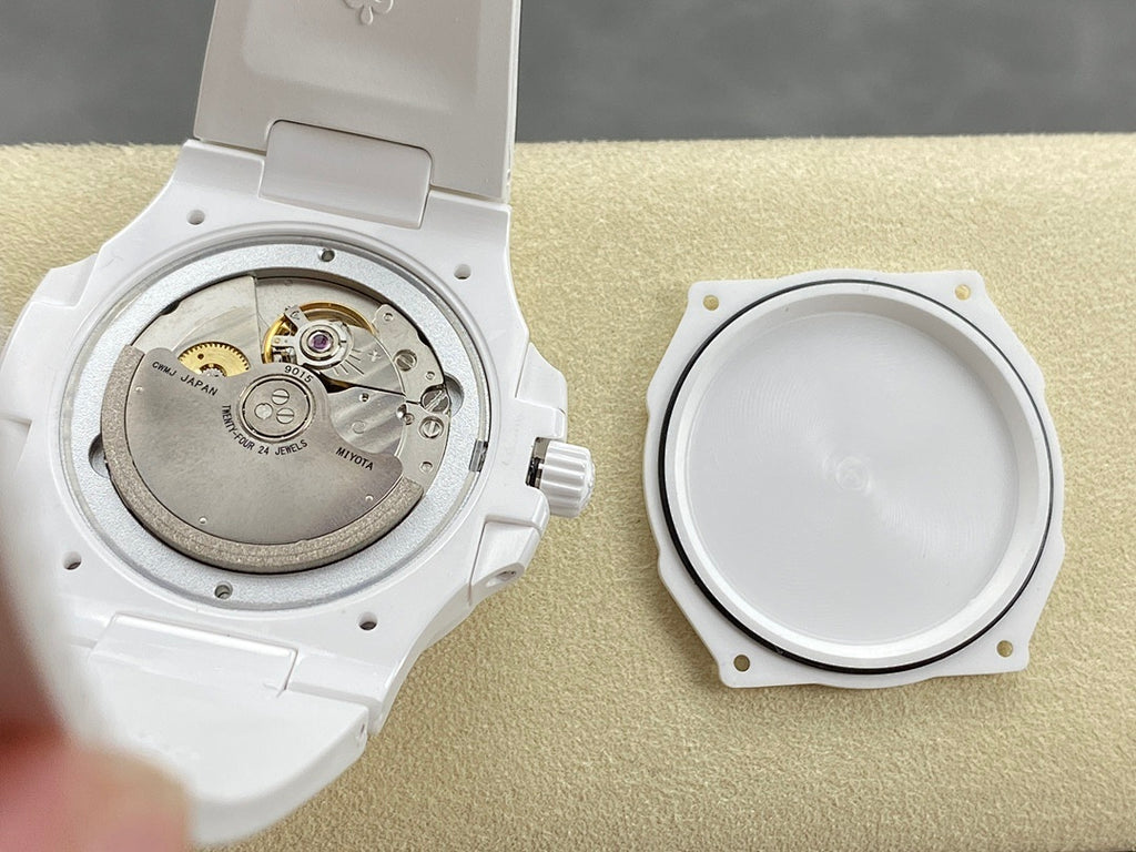 Patek Philippe watch case open view, showing silver-toned movement and case back