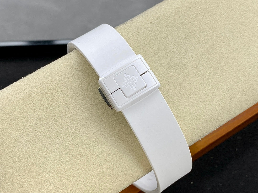 Patek Philippe wristwatch with white buckle strap and engraved clasp on the band