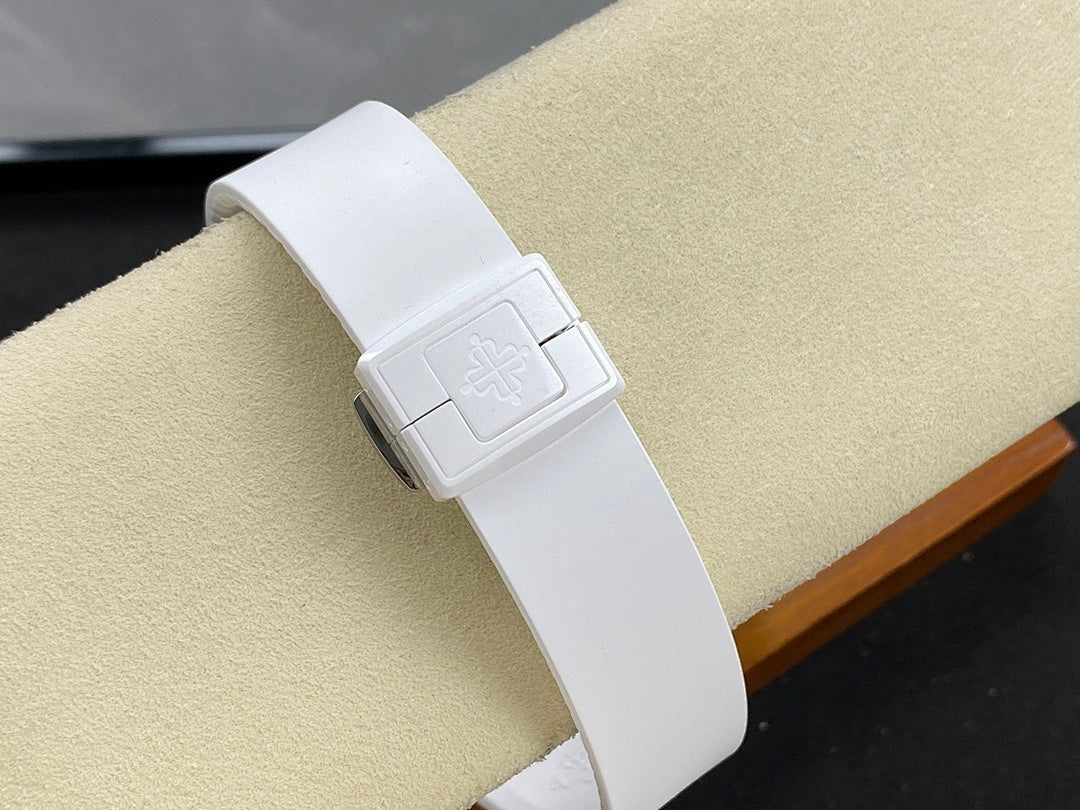 White rubber-style watch strap with deployment clasp and engraved emblem.