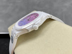 White watch case from side view showing crown and part of purple dial.