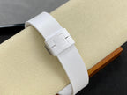 White wristwatch on a white strap with clasp and a stamped emblem on the strap.