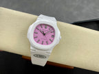 White wristwatch on wrist with pink dial, baton markers, and date window at 3 o’clock.