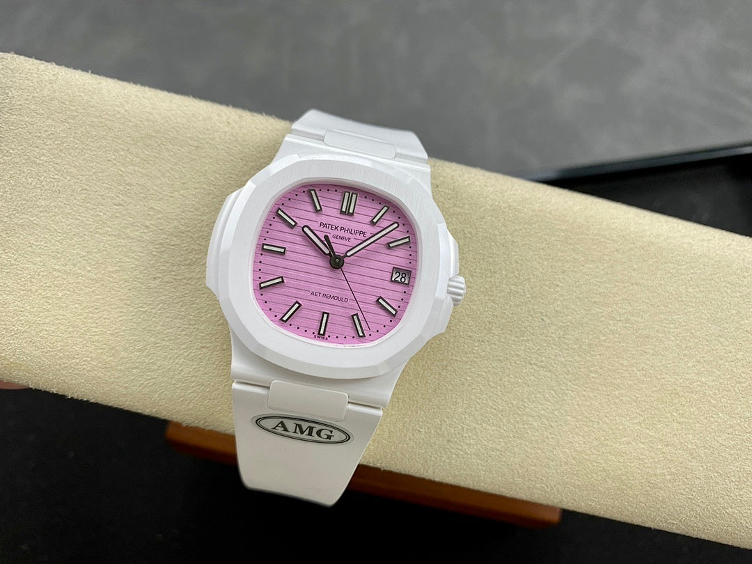 White wristwatch on wrist with pink dial, baton markers, and date window at 3 o’clock.