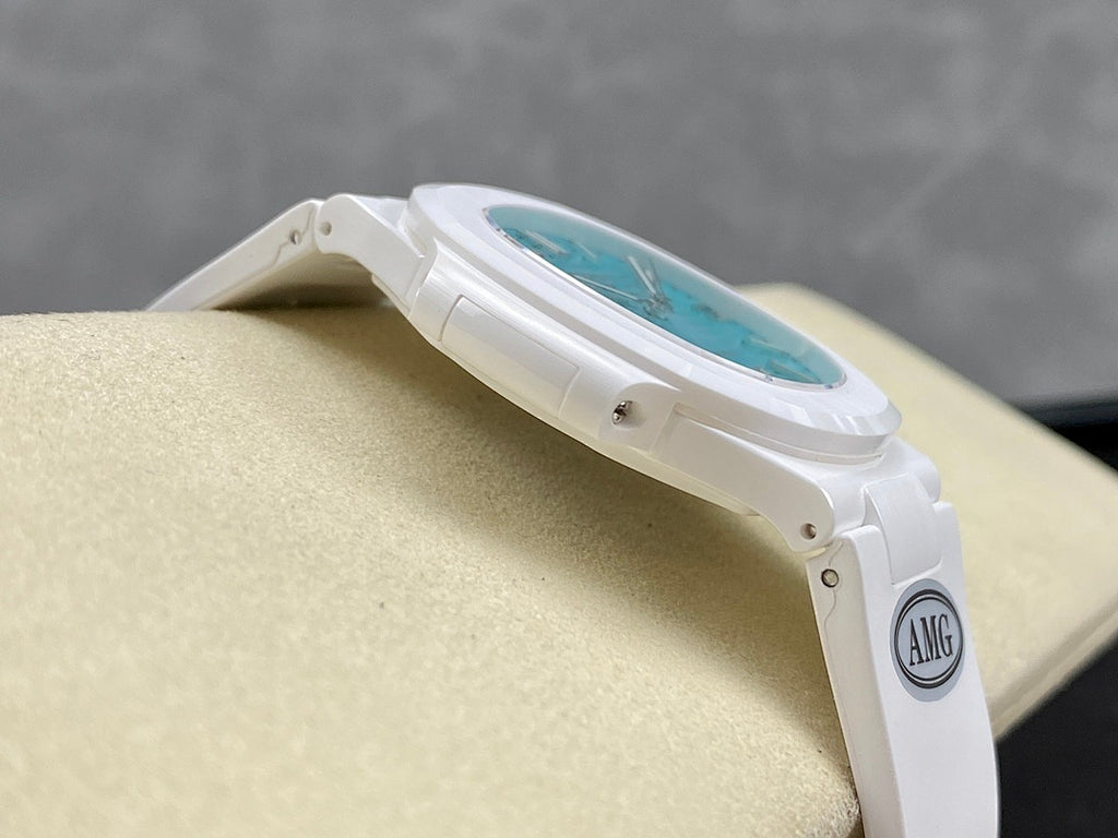 White wristwatch angled view, turquoise dial and case edge with strap