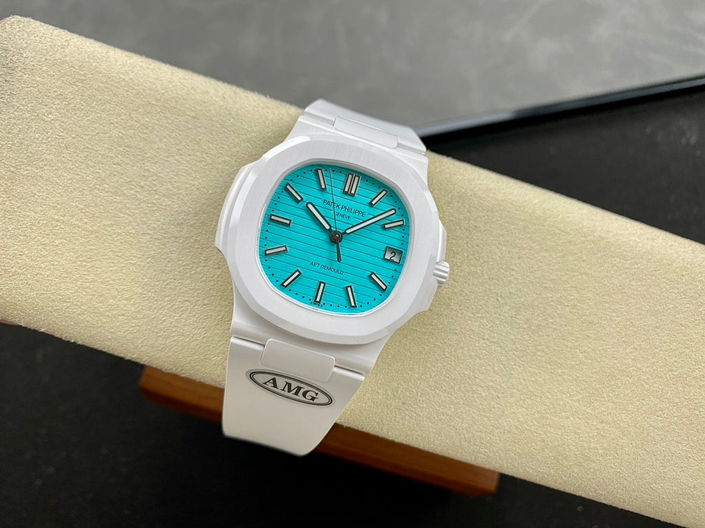 White wristwatch on strap with turquoise dial and dark baton indices