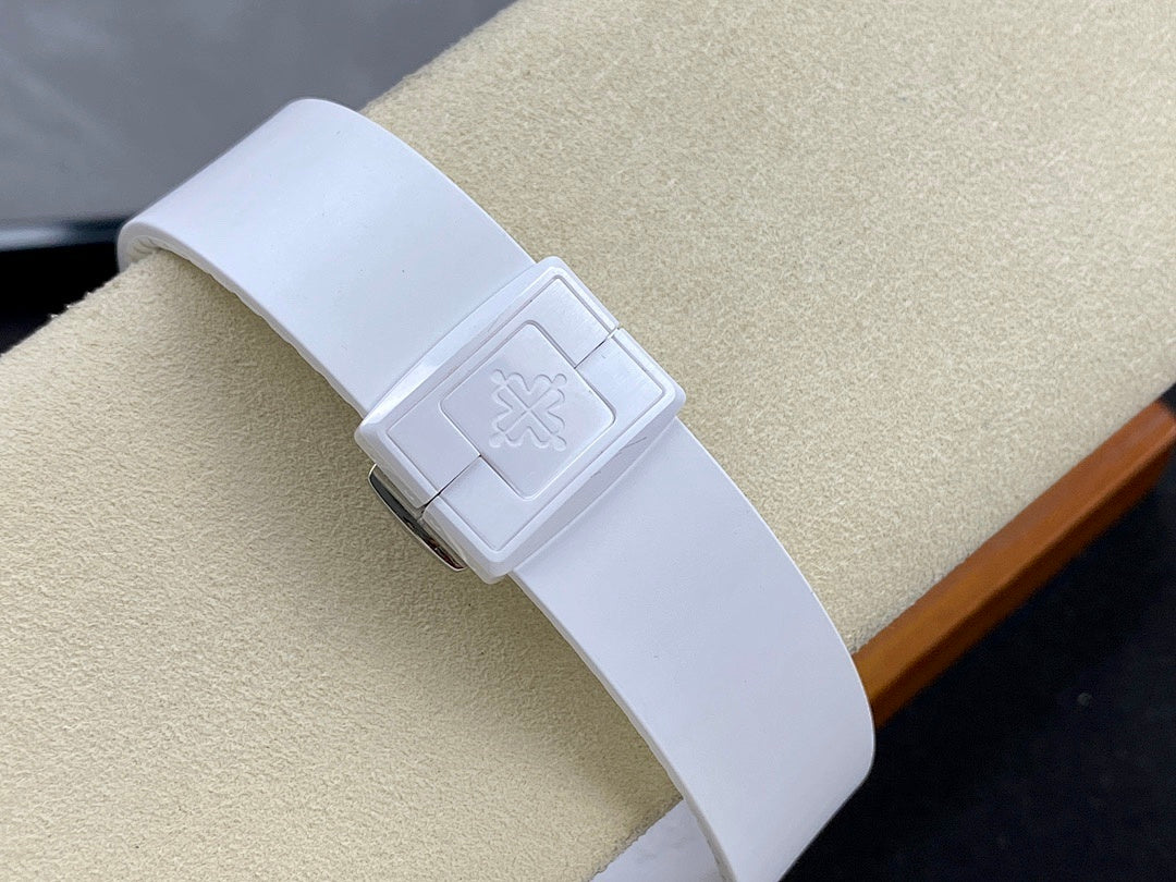 Patek Philippe wristwatch buckle on white strap with embossed logo detail