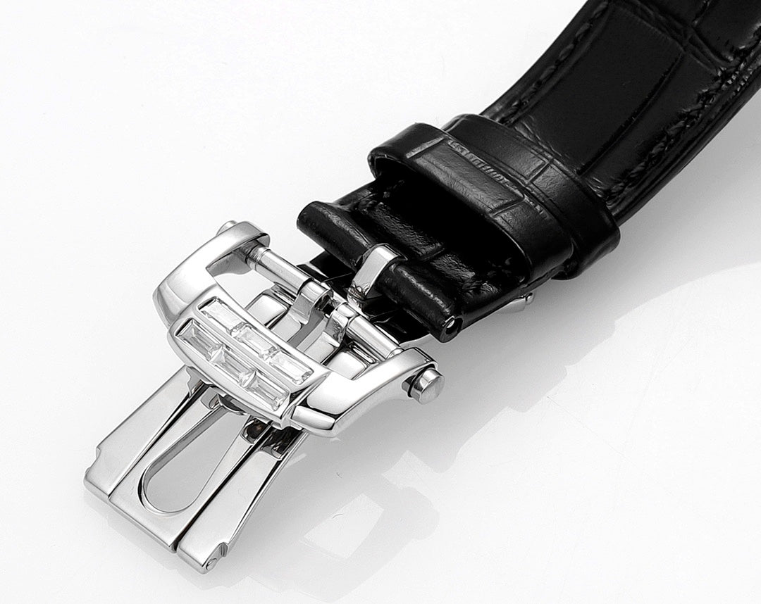 Patek Philippe watch with black leather strap and silver clasp, side view.