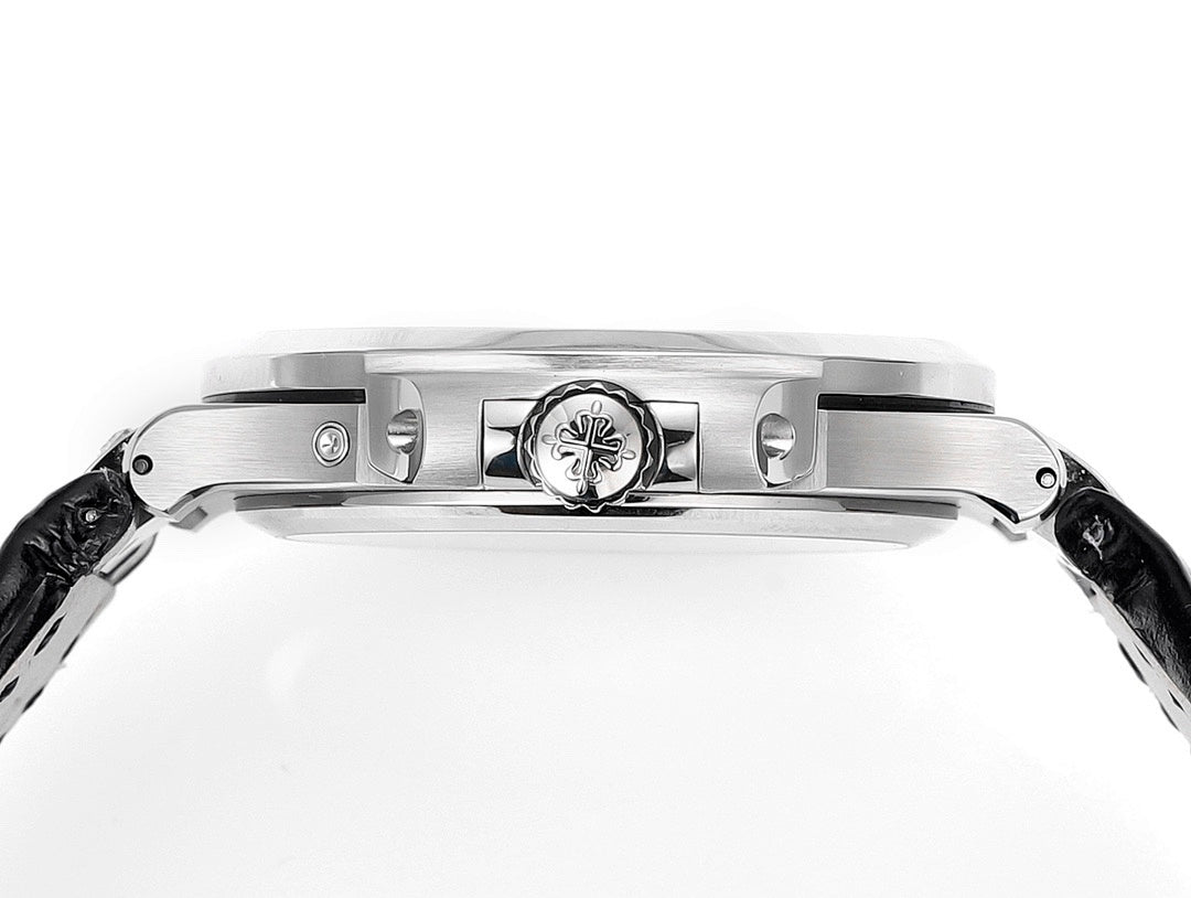 Patek Philippe watch case top with engraved emblem and polished bezel, side view.