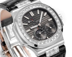 Patek Philippe watch dial close-up with black face, baton markers, and moonphase subdial.