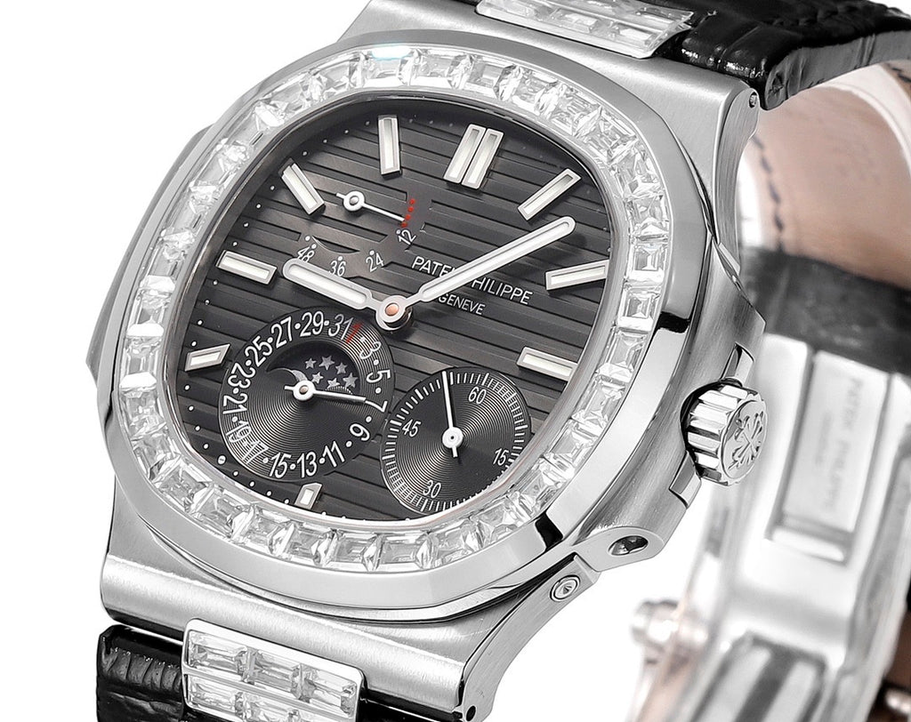 Patek Philippe watch close-up with black dial, diamond bezel, and silver crown at right.