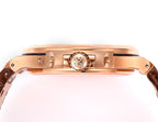 Patek Philippe rose-gold wristwatch case side with crown and embossed emblem