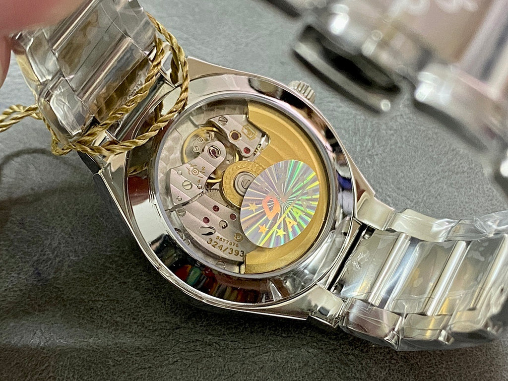 Patek Philippe watch with case open, visible movement and gold-toned interior