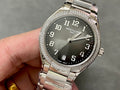 Patek Philippe steel watch with diamond bezel and dark dial, bracelet visible