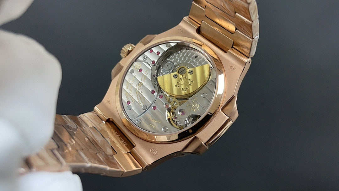 Patek Philippe watch case with see-through back, gold-tone links and rotor