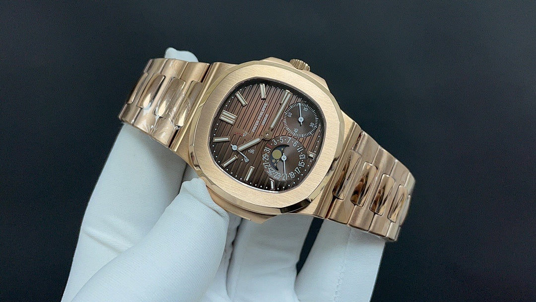Patek Philippe watch angled view with dark dial and gold-tone metal bracelet