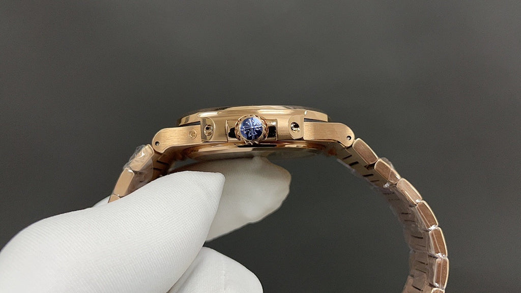 Patek Philippe rose gold wristwatch side with crown guard and blue gemstone