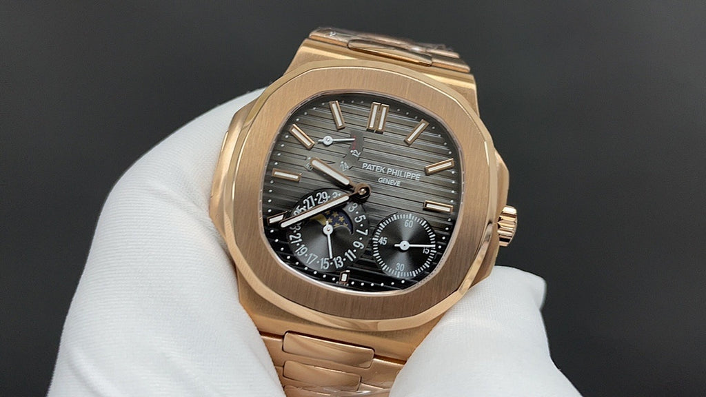 Patek Philippe rose gold wristwatch with black dial and date window