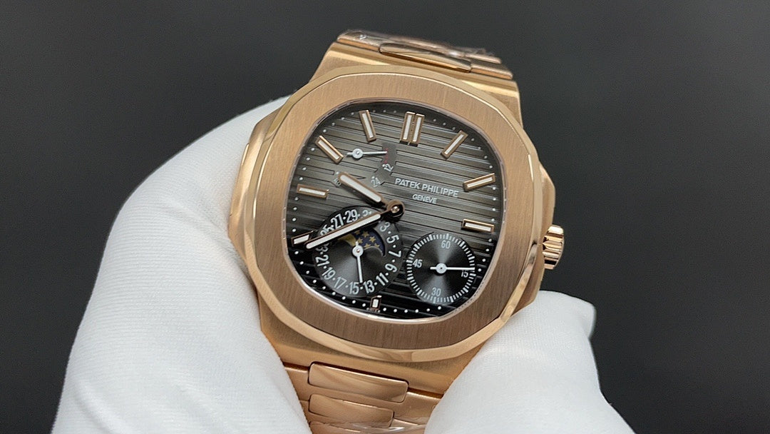 Patek Philippe rose gold wristwatch with black dial and date window