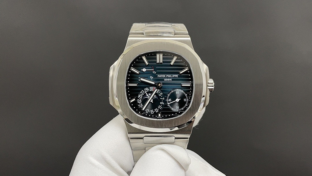Patek Philippe watch with silver bracelet and dark blue dial, multiple subdials.