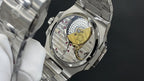Patek Philippe watch caseback with exposed mechanical movement and gold plate.